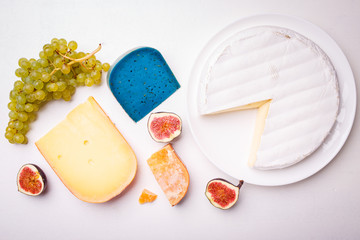 Variety of different cheese with nuts on the table