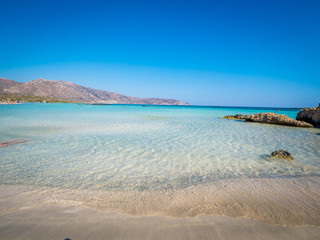 Crete, Greece - Jul 14, 2018: Elafonisi, a paradise beach with turquoise water, an island located close to the southwestern corner of the Mediterranean island of Crete, known for its pink sand beaches