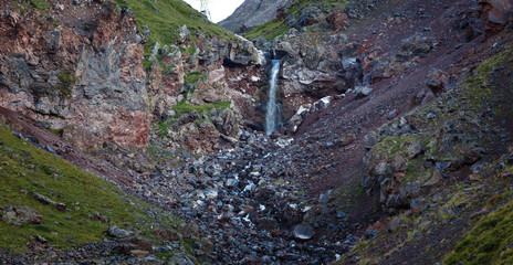 Waterfall on the rocky slopes of the Caucasus Mountains in Russia.