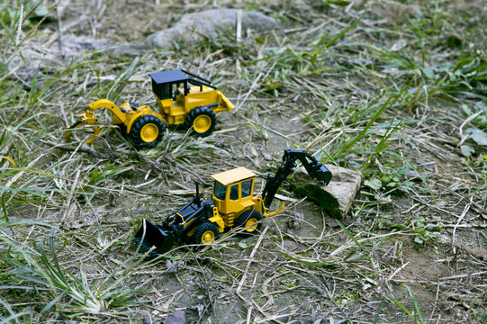 Two excavator cars that organize around to make way.