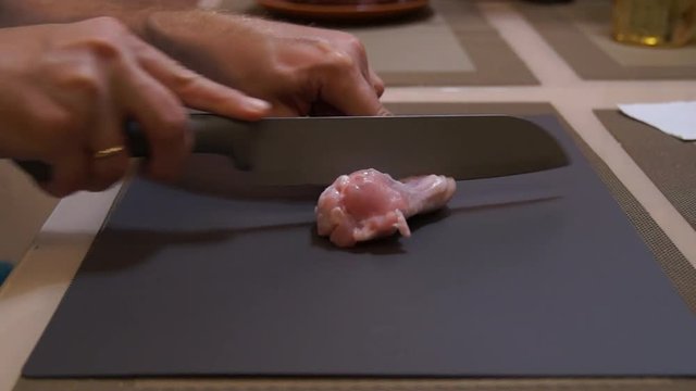 Chicken wings. Chef cooking wings. Man hands cuts chicken. Buffalo