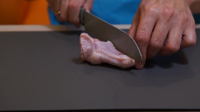 Chicken wings. Chef cooking wings. Man hands cuts chicken. Buffalo