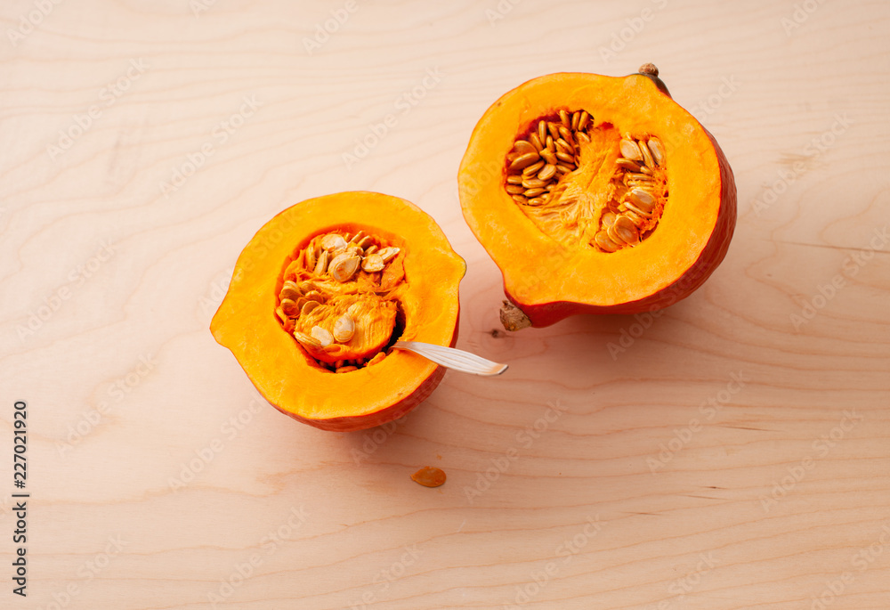 Wall mural cooking pumpkin. cleaning seeds with a spoon.