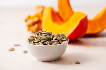 Peeled pumpkin seeds with pieces of fresh pumpkin