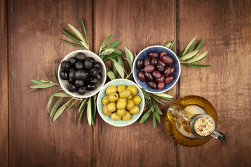 Overhead photo of various olives and olive oil with copyspace