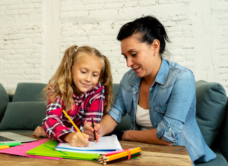 Mum and daughter doing homework together at home