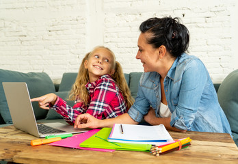 Happy mother and daughter doing homework and studying together