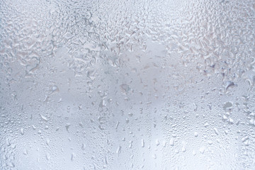Thawed frosty drawing on the winter window as background or wallpaper.