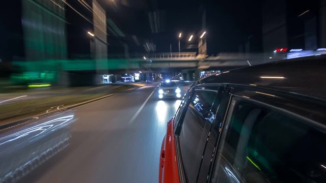 Drivelapse from side of car moving on a night avenue in city timelapse hyperlapse