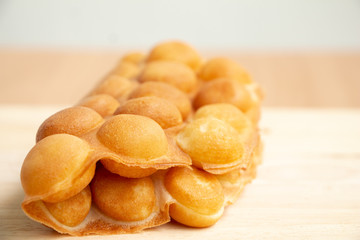 Dessert Waffle Hong Kong or bubble waffle  on wood background.