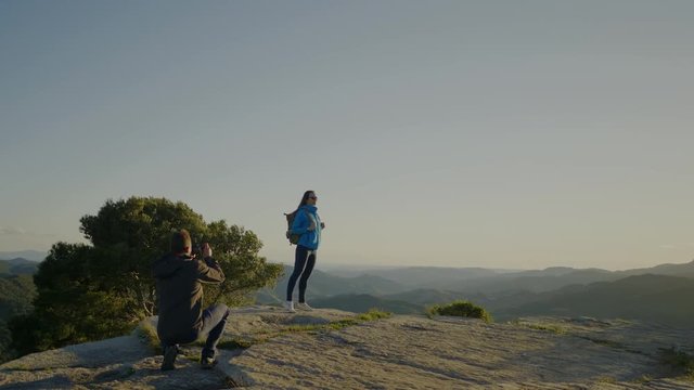 Couple standing on top of mountain