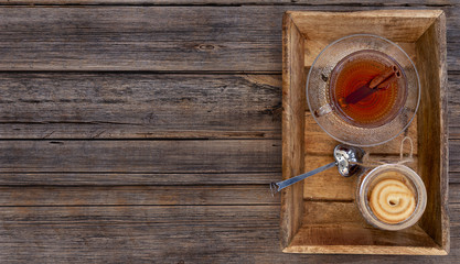 Cup of tea with cookies on a vintage table top background with copy space. Flat layout composition..