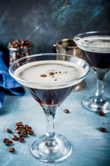 Coffee drink ideas, espresso martini cocktail, two glasses on blue concrete background copy space