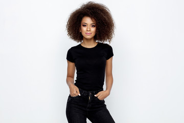 Beautiful african american woman with an afro hairstyle wearing black clothes and looking at camera...