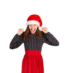 carefree happy and joyful good-looking raises hands up. emotional girl in santa claus christmas hat isolated on white background. holiday concept