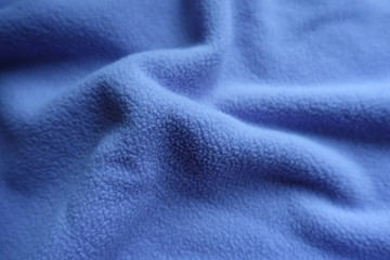 Fototapeta na wymiar Simple blue fleece fabric in soft folds