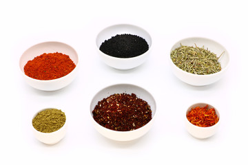 different spices in a white ceramic cup, isolated