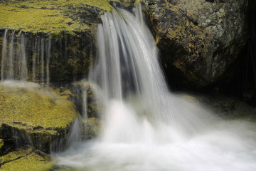 small waterfall on mountain brook