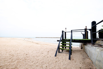 Old wooden stairs to the tropical beach