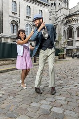 A couple of lovers dressed retro style dancing  in the streets of Montmartre, Paris, France