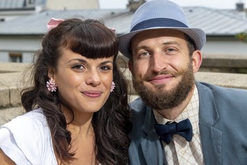 A couple of lovers,  dressed retro style , sitting on a bench, in a park at Montmartre, Paris,...