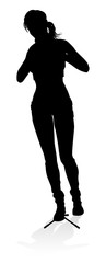 A woman singer pop, country music, rock star or even hiphop rapper artist vocalist singing in silhouette