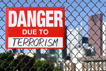  Sign danger due to terrorism hanging on the fence