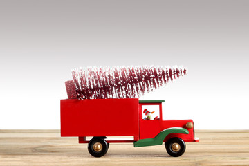 close up on a toy car with christmas tree isolated on grey background with copy space