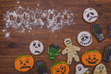 Sweet snacks on the table in the form of ghosts, zombies, pumpkin smileys and coffins. Halloween party Preparing