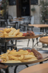 Grilled sausage with sauce and french fries