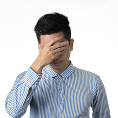 Fototapeta premium Portrait stressed and anxiety handsome young asian man wearing a blue shirt isolated on white wall background.