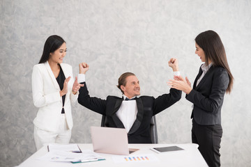 Celebrating success Cheerful young people looking excited. Successful entrepreneurs and business people achieving goals