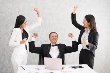 Celebrating success Cheerful young people looking excited. Successful entrepreneurs and business people achieving goals