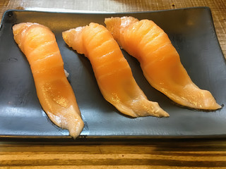 Sushi in the black plate. Sushi is a type of food preparation originating in Japan.