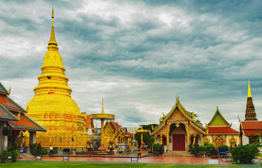 Fototapeta premium Golden Pagoda in Wat Phra That Hariphunchai temple in Lamphun province,Thailand.