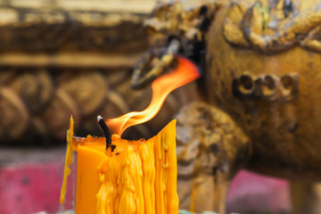 Fire on candlewick with religion background