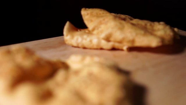 Indian Papadam fried savory treat, cooked and raw indoors isolated on wooden table