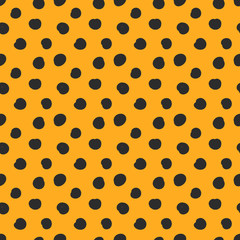 Doodle black dots or speckles on orange background pattern