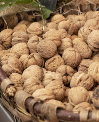 View to a basket of walnuts at a market stall.