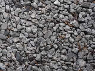 Crushed grey stone on the ground texture background