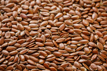 Background texture of seeds of dark brown flax.