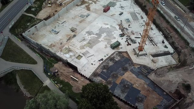 viewo of drone frop down to top on crane at construction site