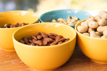 Assortment of mixed nuts on wood table background 