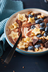 healthy banana smoothie bowl with blueberry chocolate walnuts