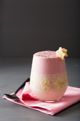 healthy layered raspberry banana smoothie in glass