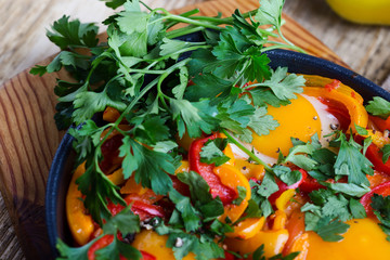 Shakshuka, fried eggs cooked in tomatoes and bell peppers sauce