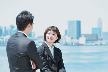 屋外で立って話をする会社員