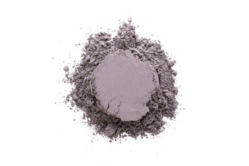 Pile of yellow  black cosmetic clay isolated on white background