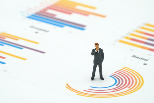 Miniature people businessmen analyze standing on Circle graph with performance as background strategy concept and Business concept with copy space. - Powered by Adobe