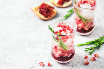 Rosemary pomegranate infused water with ice cubes. Selective focus, space for text.